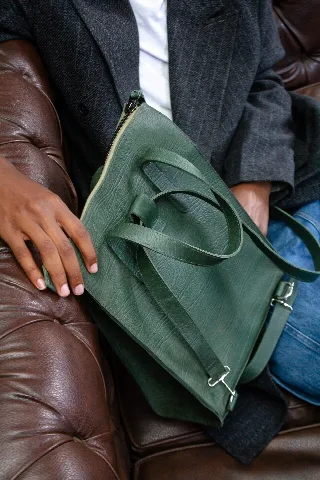 Green leather zip tote bag, close up