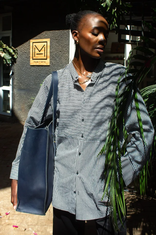 Striped oversized cotton shirt worn with a navy leather tote